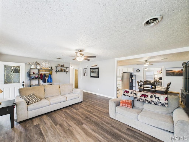 14469 Tailor Rd, Saint Robert, MO 65584 - living room with ceiling fan, a textured ceiling, wood finished floors, and baseboards
