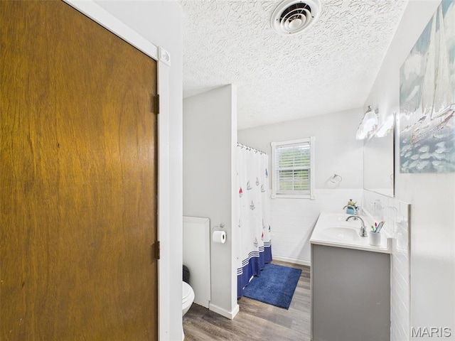 14469 Tailor Rd, Saint Robert, MO 65584 - bathroom with wood finished floors, toilet, vanity, a shower with shower curtain, and baseboards