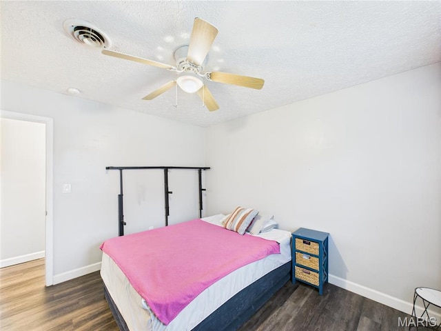 14469 Tailor Rd, Saint Robert, MO 65584 - bedroom featuring wood finished floors, a textured ceiling, baseboards, and a ceiling fan