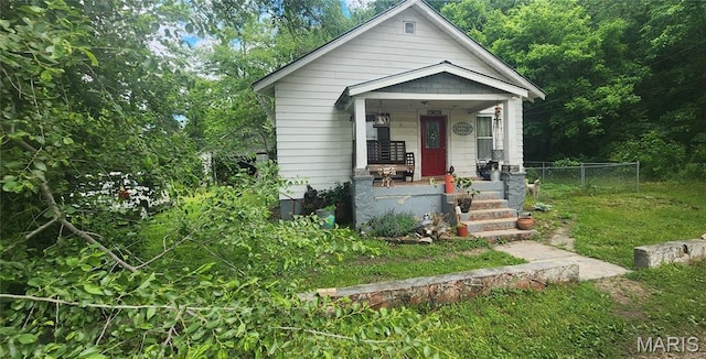 view of front facade with a porch and fence