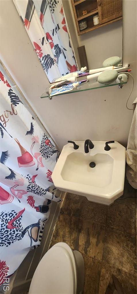 bathroom featuring toilet and a sink