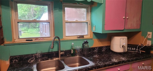 kitchen view of a sink and dark countertops