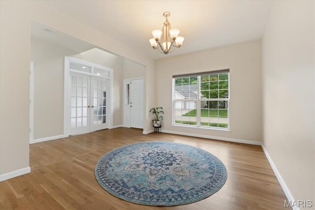 1417 Red Oak Plantation Dr, Ballwin, MO 63021 - entrance foyer featuring a chandelier, baseboards, wood finished floors, and french doors