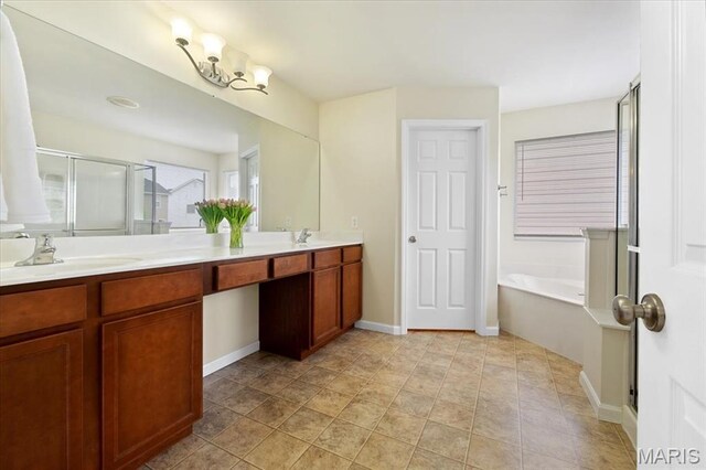 1417 Red Oak Plantation Dr, Ballwin, MO 63021 - bathroom featuring double vanity, a stall shower, a garden tub, baseboards, and a chandelier