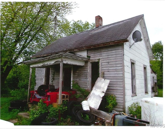 456 E 2595th Ave, Ramsey, IL 62080 - view of home's exterior with a chimney and a shingled roof