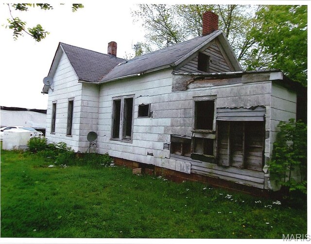 456 E 2595th Ave, Ramsey, IL 62080 - back of house featuring a chimney and a yard
