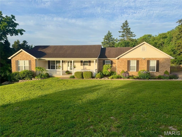 single story home with brick siding, covered porch, and a front lawn