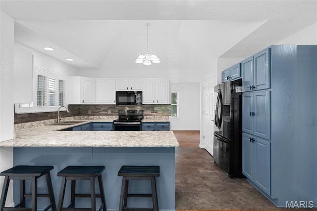 kitchen with black appliances, blue cabinets, a peninsula, a chandelier, and recessed lighting