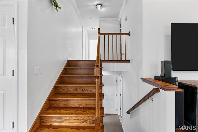 stairway featuring baseboards