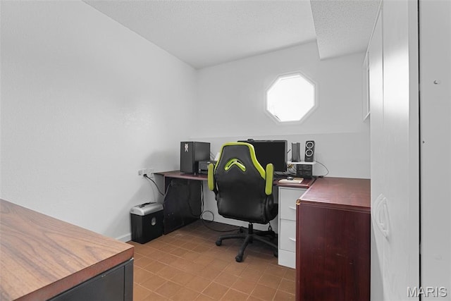 office space featuring a textured ceiling and baseboards