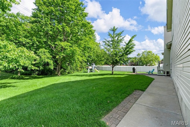 view of yard featuring a playground and a patio area