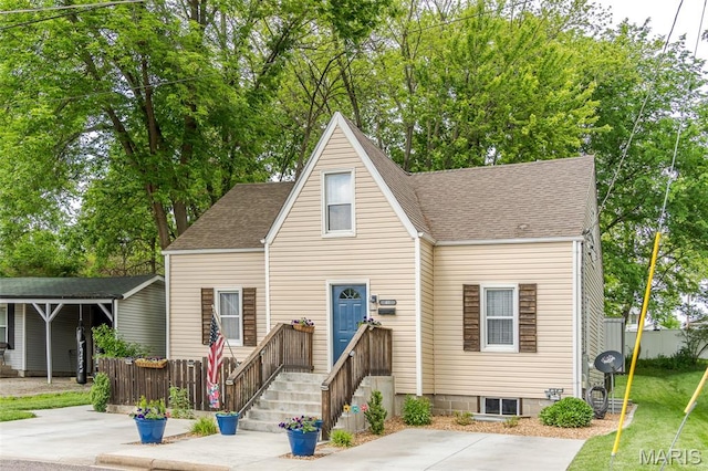 view of front of property with a shingled roof and fence
