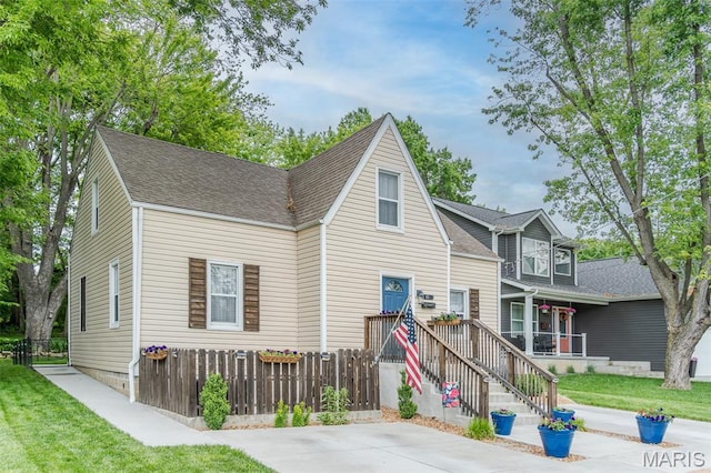 traditional-style home featuring a shingled roof