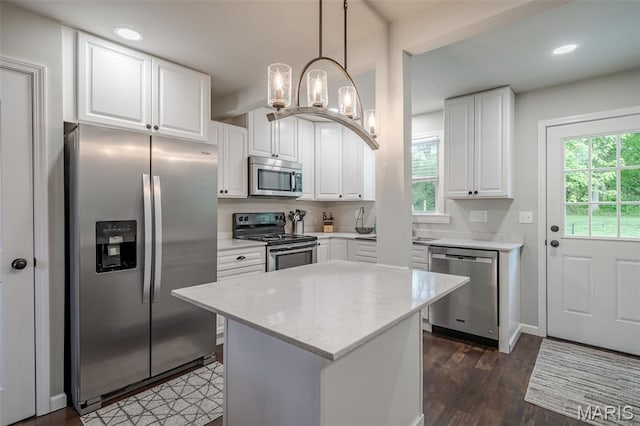 kitchen with stainless steel appliances, white cabinets, dark wood finished floors, a chandelier, and recessed lighting