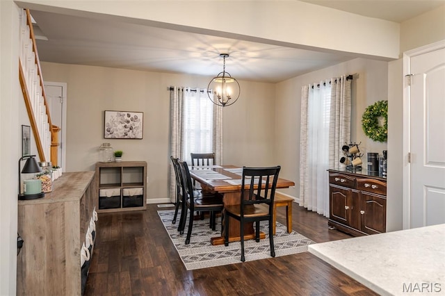 dining room featuring dark wood-style floors, a chandelier, baseboards, and stairs