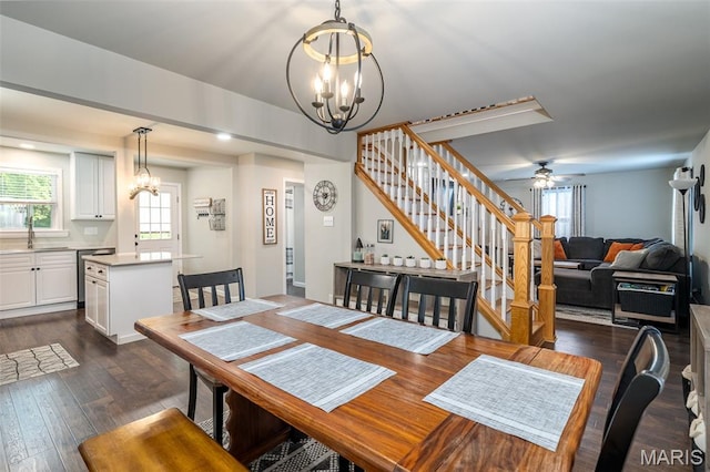 dining space with a chandelier, stairway, and healthy amount of natural light