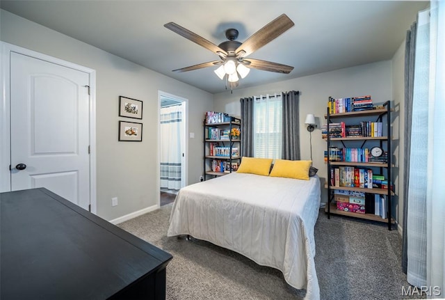 carpeted bedroom featuring baseboards and ceiling fan