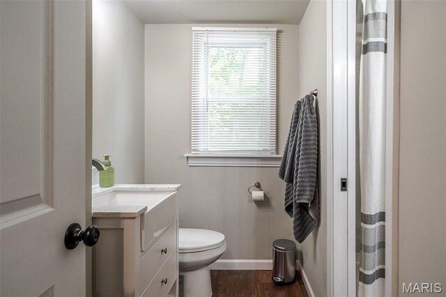 full bath with wood finished floors, baseboards, toilet, vanity, and a shower with shower curtain
