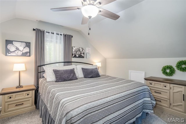 bedroom with carpet floors, vaulted ceiling, and a ceiling fan