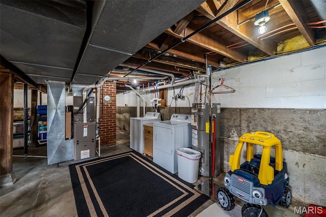 unfinished below grade area featuring washing machine and clothes dryer, water heater, and heating unit