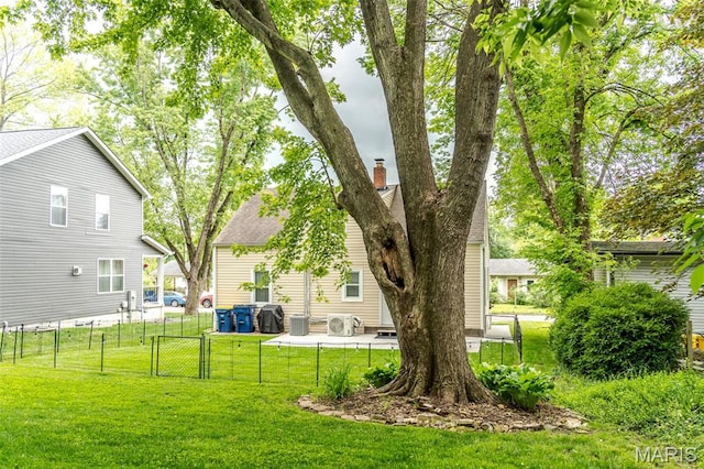 view of yard with a gate, a cooling unit, a patio, and central AC