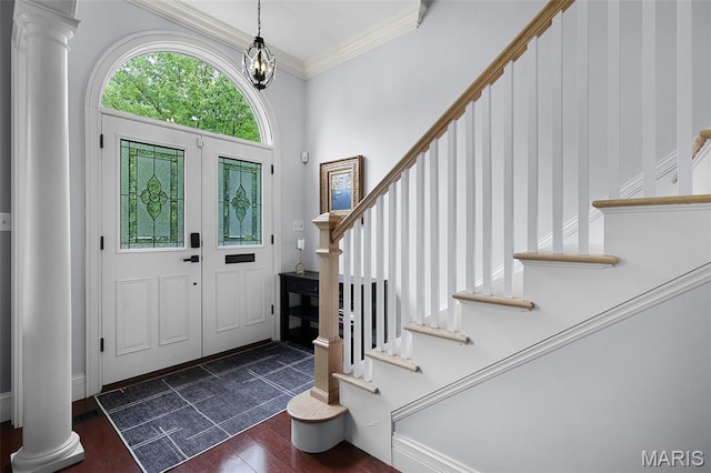 1606 Mississippi Ave, Saint Louis, MO 63104 - foyer with stairs, ornate columns, dark wood-style flooring, and crown molding