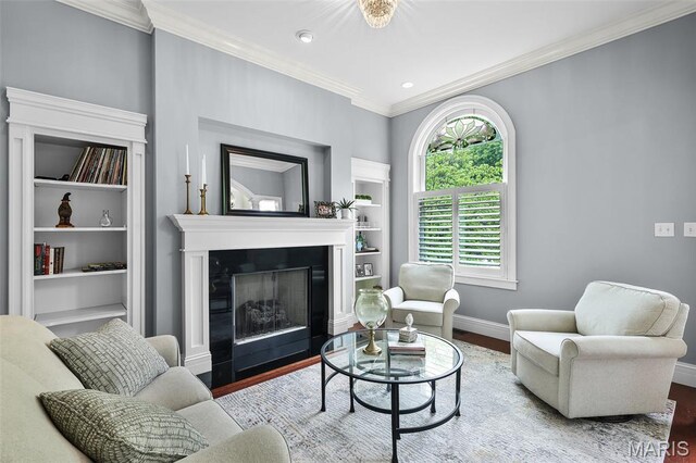 1606 Mississippi Ave, Saint Louis, MO 63104 - living room with wood finished floors, baseboards, crown molding, a fireplace, and built in features