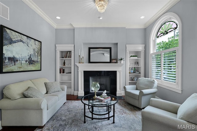 1606 Mississippi Ave, Saint Louis, MO 63104 - living area featuring a fireplace with flush hearth, crown molding, wood finished floors, and recessed lighting