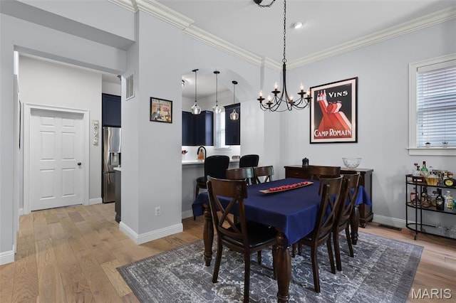 1606 Mississippi Ave, Saint Louis, MO 63104 - dining area featuring a chandelier, crown molding, light wood finished floors, plenty of natural light, and baseboards