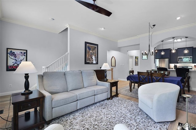 1606 Mississippi Ave, Saint Louis, MO 63104 - living area with wood finished floors, ornamental molding, a chandelier, baseboards, and stairs