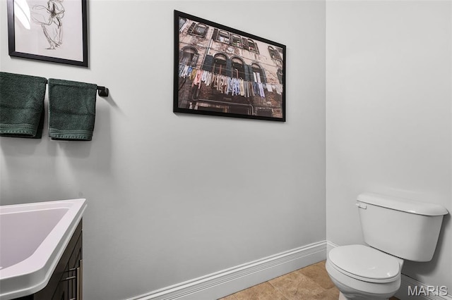 1606 Mississippi Ave, Saint Louis, MO 63104 - bathroom featuring baseboards, toilet, and vanity