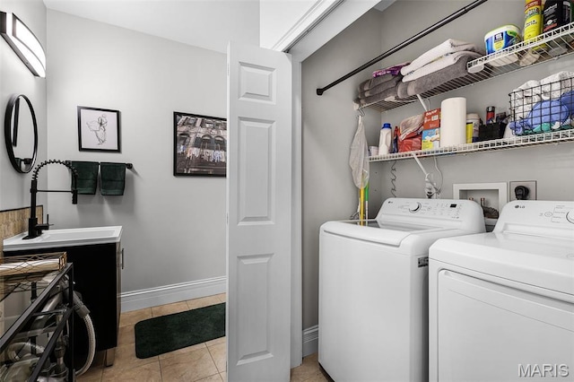 1606 Mississippi Ave, Saint Louis, MO 63104 - laundry area with washing machine and clothes dryer, light tile patterned floors, and baseboards
