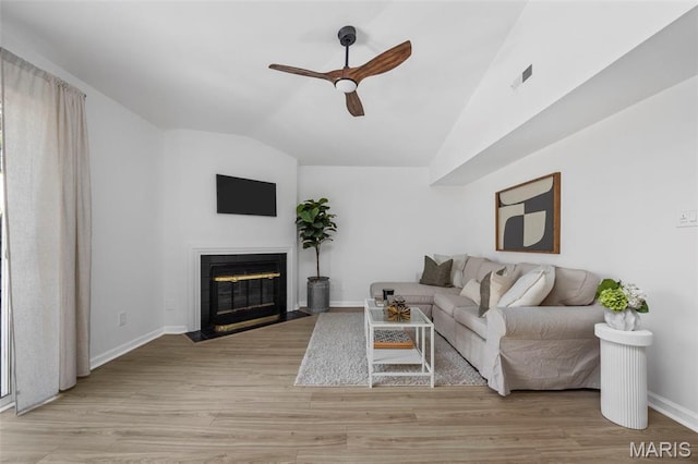 8917 Cardinal Ter, Saint Louis, MO 63144 - living area with vaulted ceiling, a ceiling fan, a fireplace with flush hearth, baseboards, and light wood finished floors
