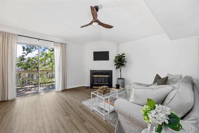 8917 Cardinal Ter, Saint Louis, MO 63144 - living room with a tile fireplace, wood finished floors, ceiling fan, and baseboards