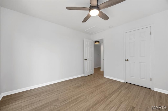8917 Cardinal Ter, Saint Louis, MO 63144 - unfurnished bedroom with attic access, light wood-style floors, baseboards, and a ceiling fan