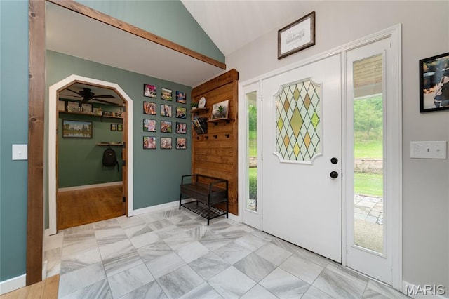 entryway featuring lofted ceiling and arched walkways