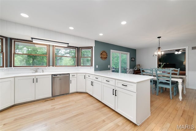 kitchen with dishwasher, a peninsula, light wood-type flooring, light countertops, and white cabinets