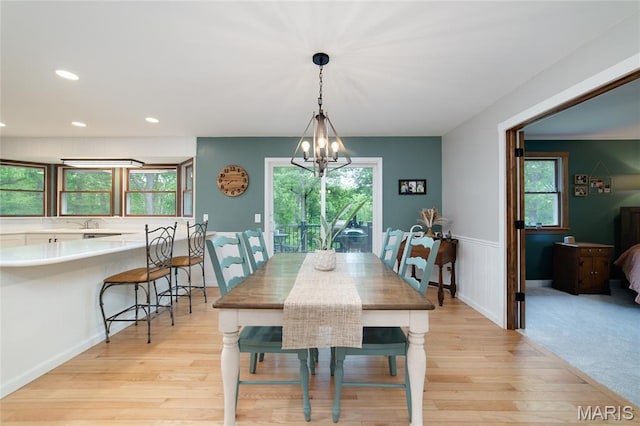 dining space featuring light wood-style floors, recessed lighting, and a chandelier