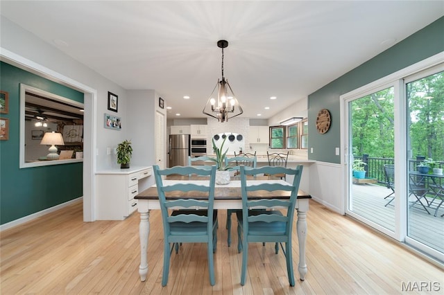 dining area featuring a chandelier, light wood finished floors, baseboards, and recessed lighting