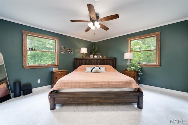 bedroom featuring multiple windows, carpet, baseboards, and crown molding