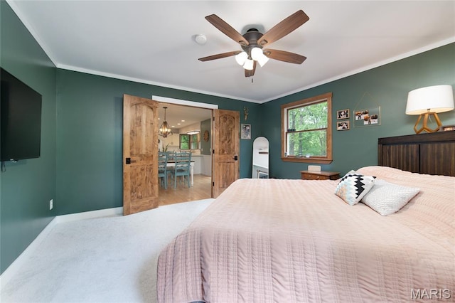 bedroom with ornamental molding, wood finished floors, baseboards, and a ceiling fan