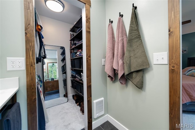 bathroom featuring connected bathroom, baseboards, and vanity