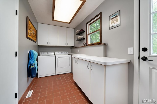 laundry area with cabinet space, washing machine and clothes dryer, and tile patterned flooring