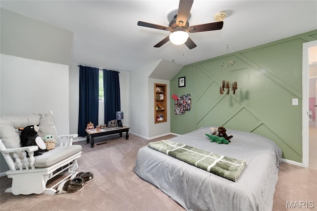 bedroom with light colored carpet, baseboards, and a ceiling fan