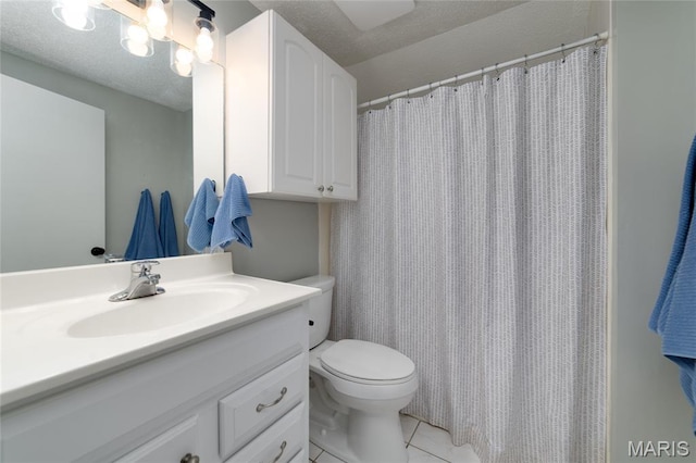 full bath with tile patterned floors, vanity, toilet, and a textured ceiling