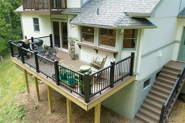 deck with stairs and outdoor dining space