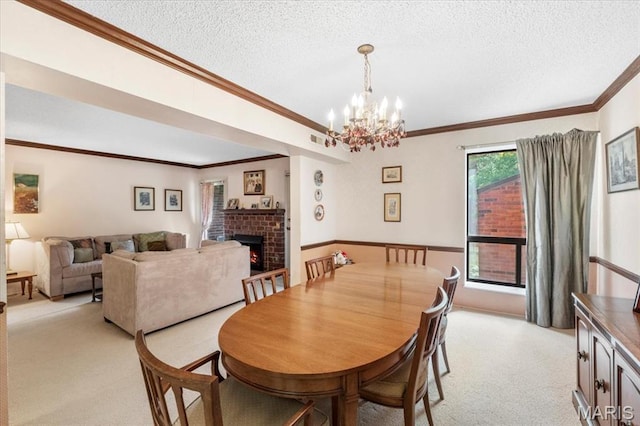572 Coeur De Royale Dr Unit 105, Saint Louis, MO 63141 - dining space with light carpet, a brick fireplace, ornamental molding, a textured ceiling, and a chandelier