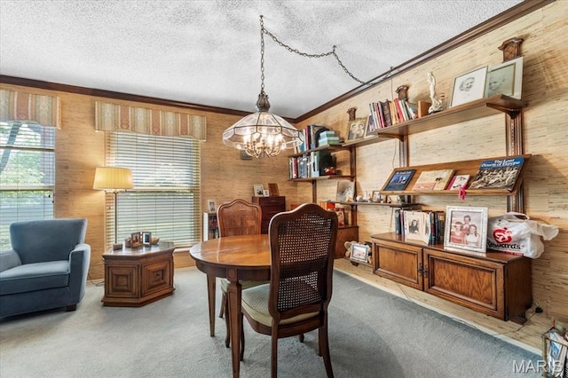 572 Coeur De Royale Dr Unit 105, Saint Louis, MO 63141 - dining area with a textured ceiling, a chandelier, carpet floors, crown molding, and wood walls