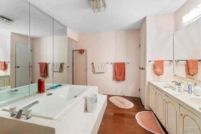 572 Coeur De Royale Dr Unit 105, Saint Louis, MO 63141 - bathroom with wood finished floors, a bath, a textured ceiling, double vanity, and a shower with door