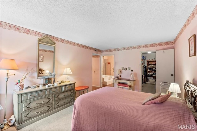 572 Coeur De Royale Dr Unit 105, Saint Louis, MO 63141 - carpeted bedroom featuring a textured ceiling, a walk in closet, and a closet